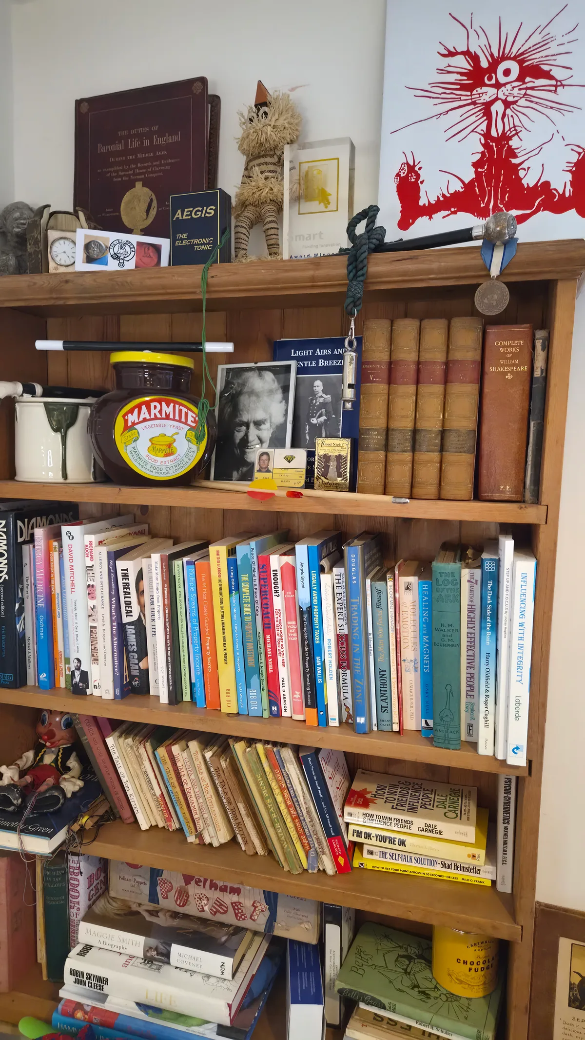Julian Campbell's bookshelf, filled with books, photographs and keepsakes